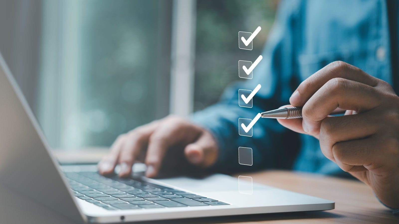 Someone making a checklist on their computer with a virtual version as an illustration.