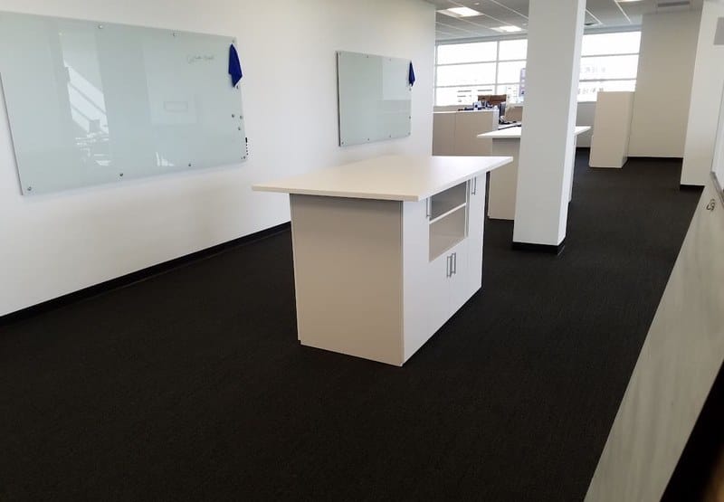 High-top collaboration table and glass whiteboards at United Grinding North America in Miamisburg, Ohio