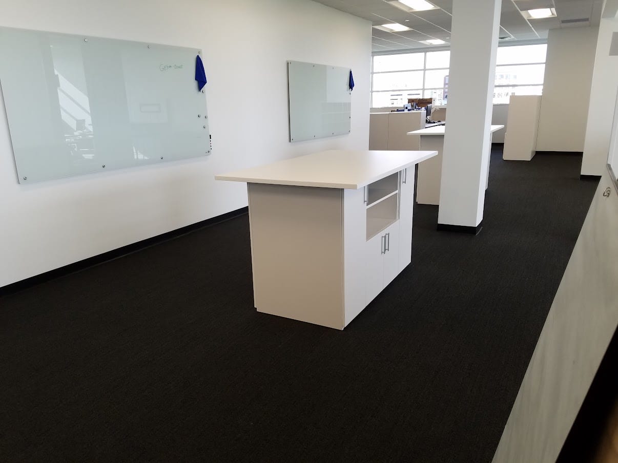 High-top collaboration table and glass whiteboards at United Grinding North America in Miamisburg, Ohio