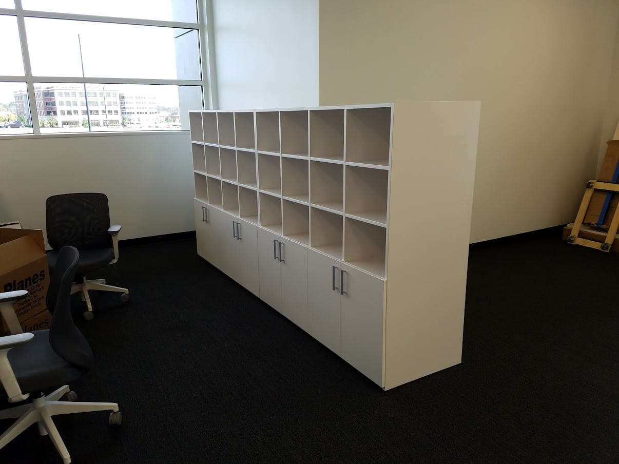 Cubby storage wall with cabinet base at United Grinding North America
