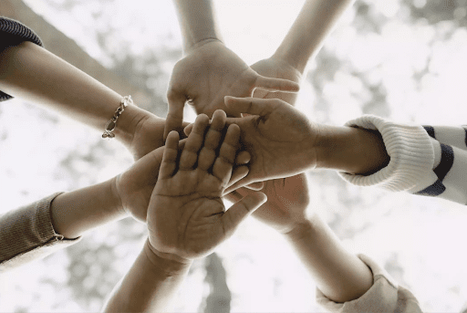 Happy employees joining hands